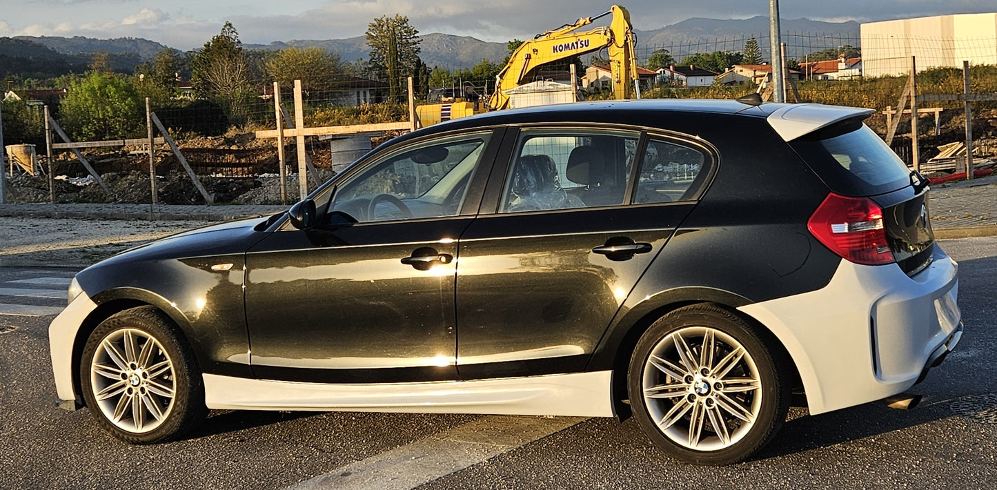 Full left side view of BMW 1 Series E87 fitted with M2 Look rear bumper, showing the integration with side skirts and flared lines.
