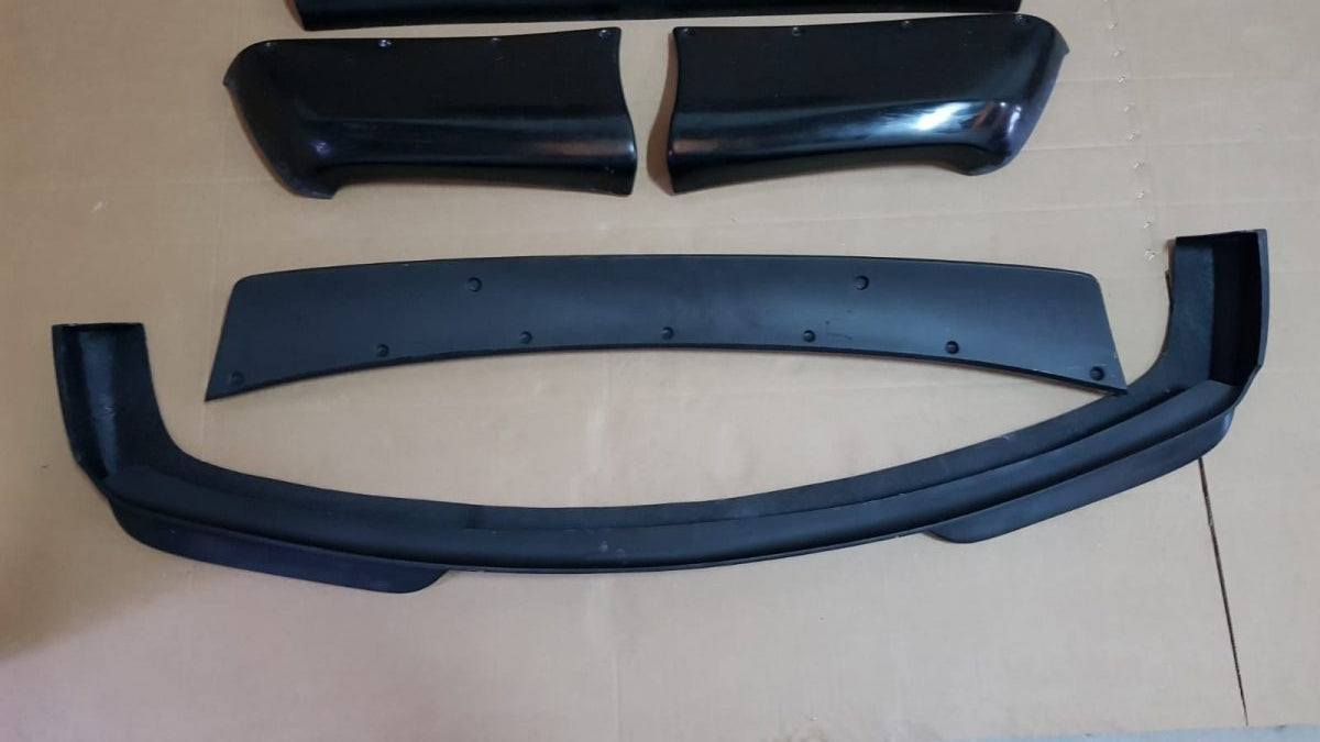 Rocket Bunny style front lip and aerodynamic splitters for BMW E36 Coupe body kit.
