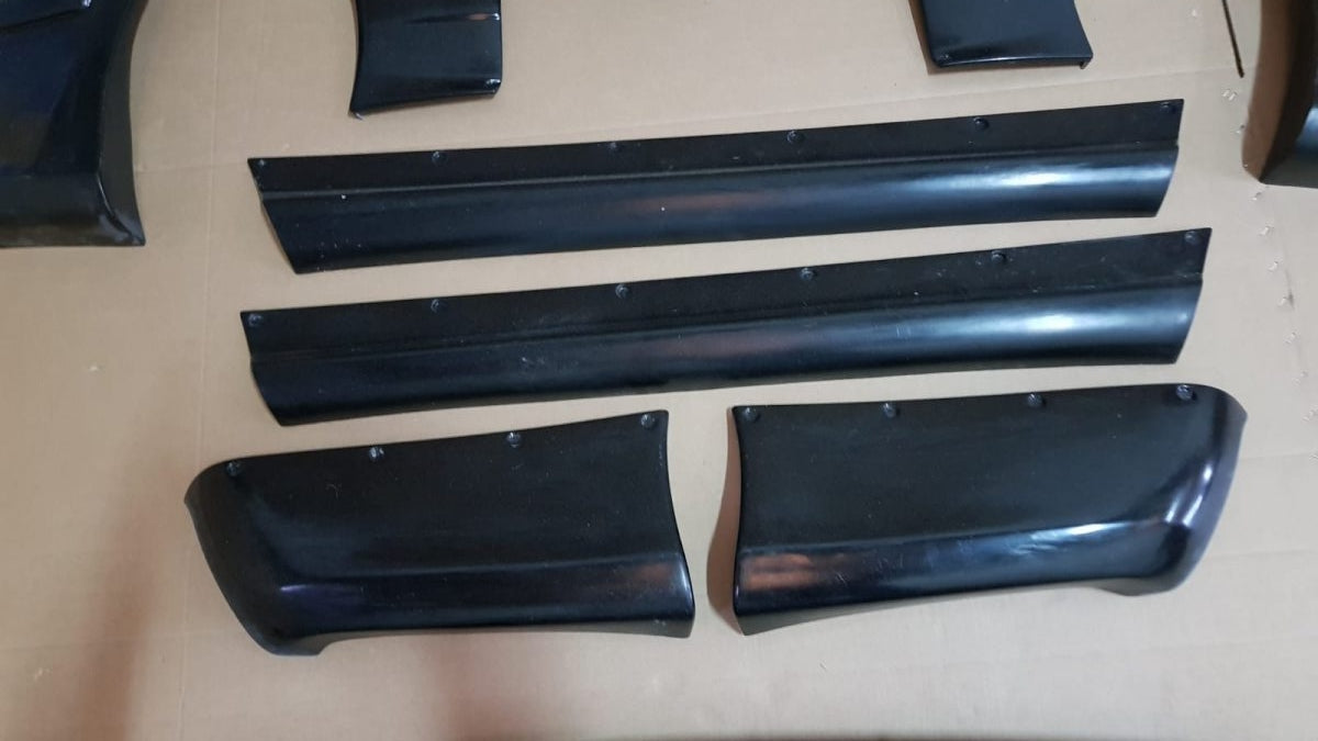 Additional bumper extensions and Rocket Bunny side parts for BMW E36 Coupe body kit.