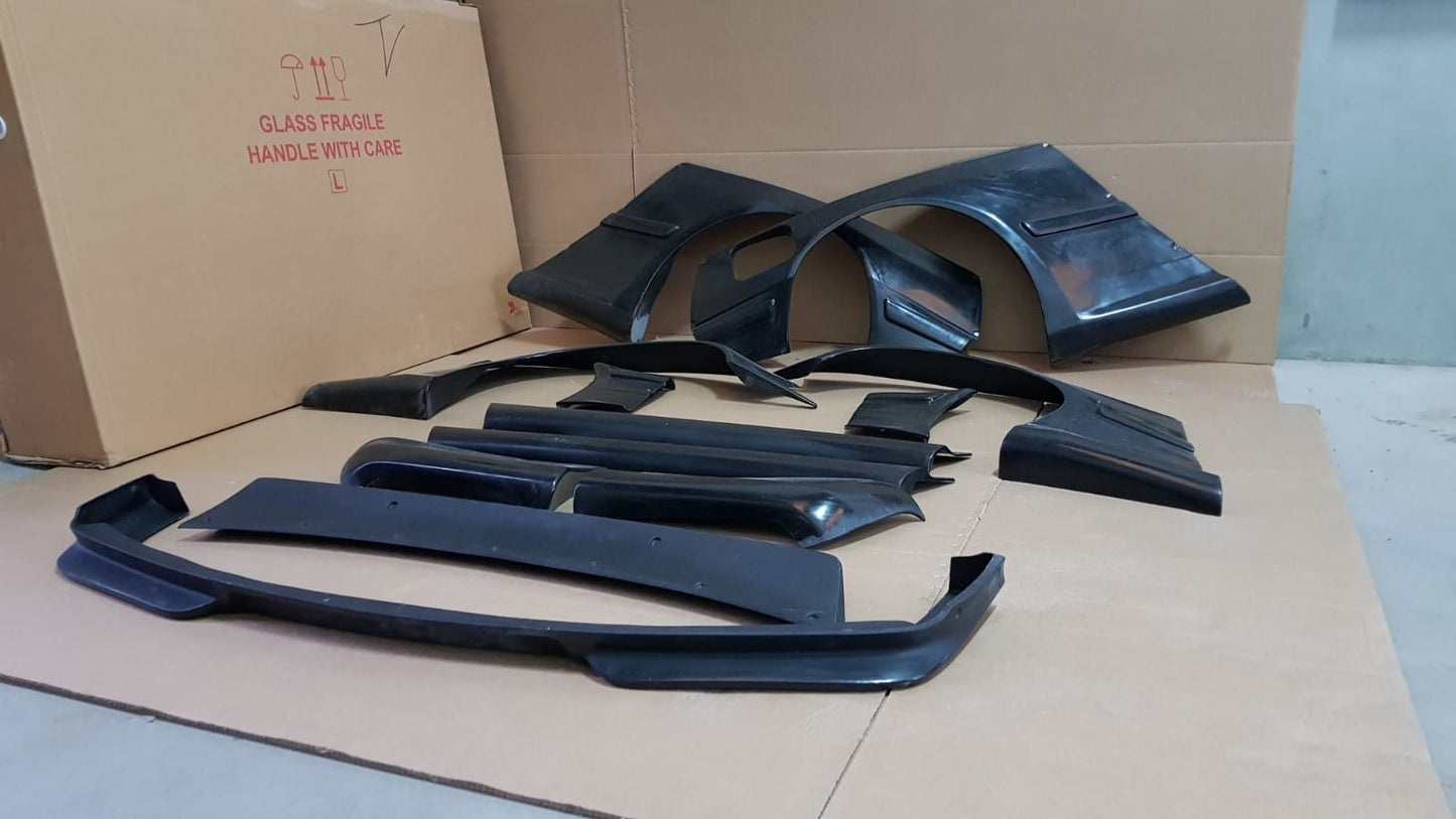 Full Rocket Bunny widebody body kit for BMW E36 Coupe with aerodynamic and wide fender parts.