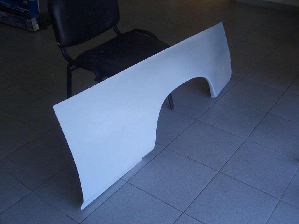 BMW 2002 Alpina fiberglass side body panel, positioned upright next to a chair.