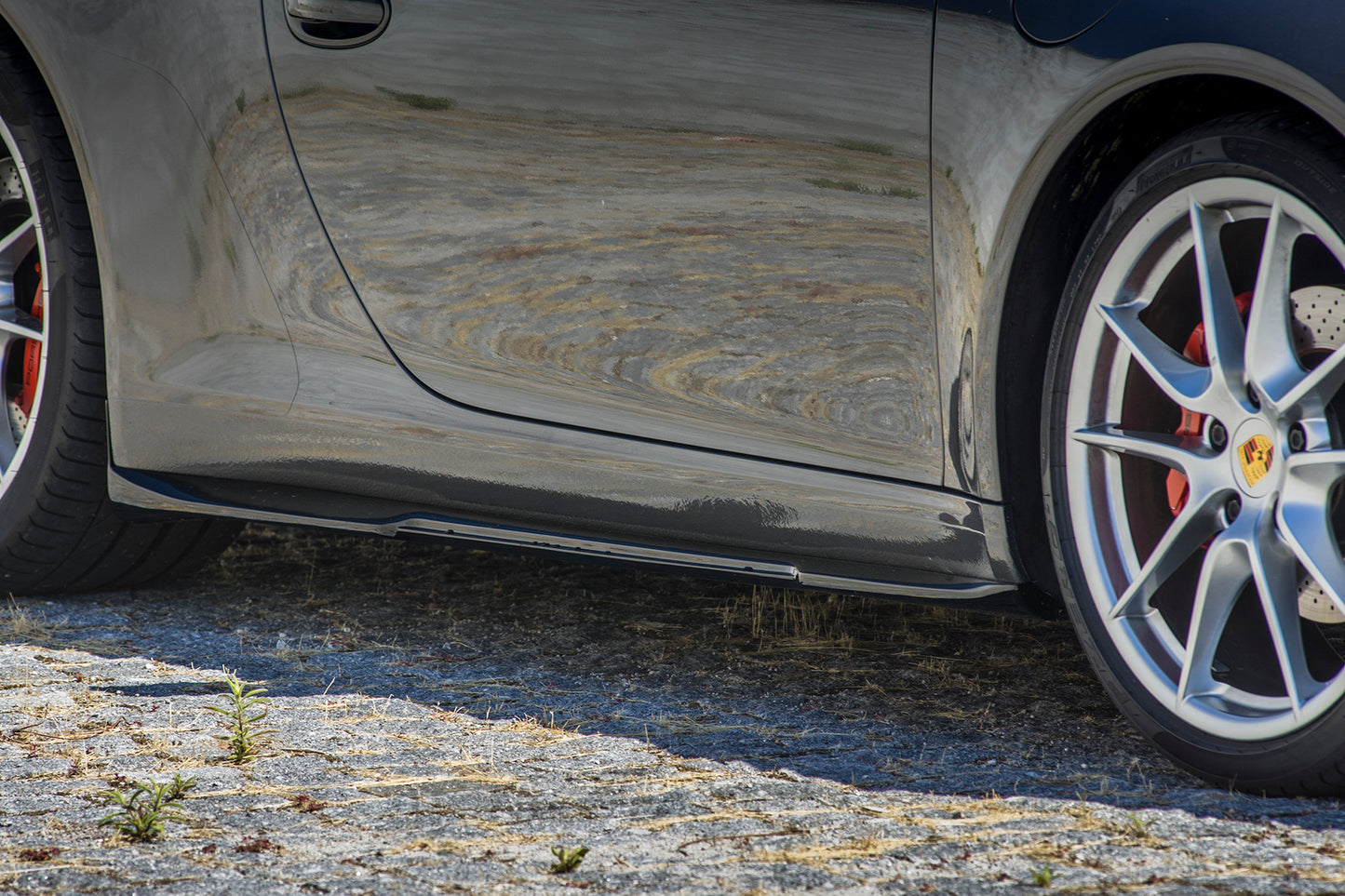 Side skirt close-up of Porsche 911 991 PH1 body kit showing sleek aerodynamic profile.