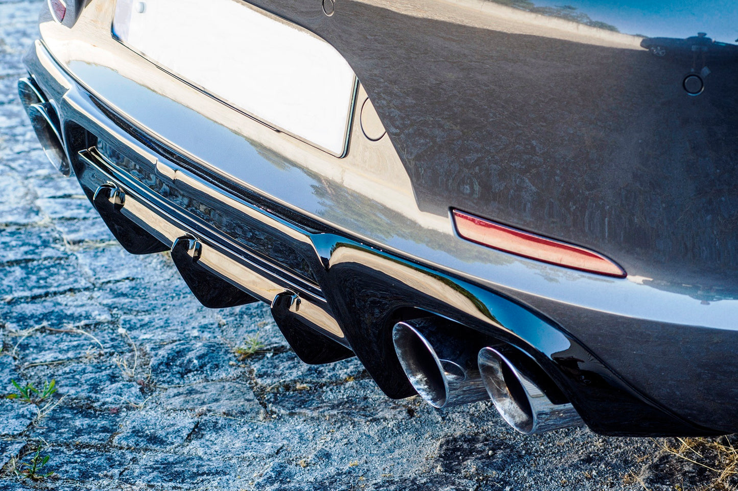 Detailed view of Porsche 911 991 PH1 rear diffuser fins and dual exhaust tips