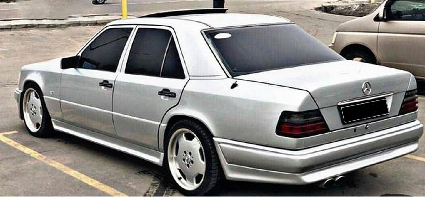 Rear bumper Mercedes W124 Berline AMG Look fitted on a silver sedan, complementing the full AMG-style body kit with a clean rear design.