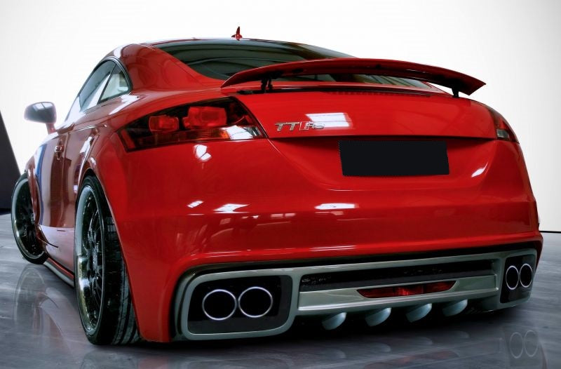 Rear view of a red Audi TT 8J featuring an upgraded rear bumper with diffuser and quad exhaust outlets for a sporty look.
