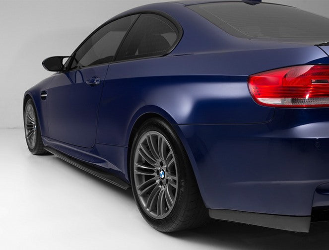 Set of side extension blades BMW E92 M-Sport installed on dark blue coupe for enhanced sporty look.