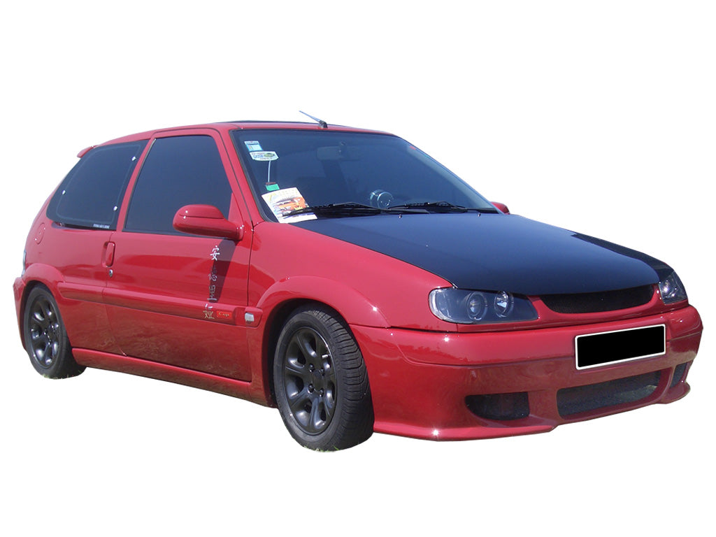 Red Citroën Saxo with Cup front bumper, featuring a sporty aerodynamic design and large air intakes for an aggressive street racing look.