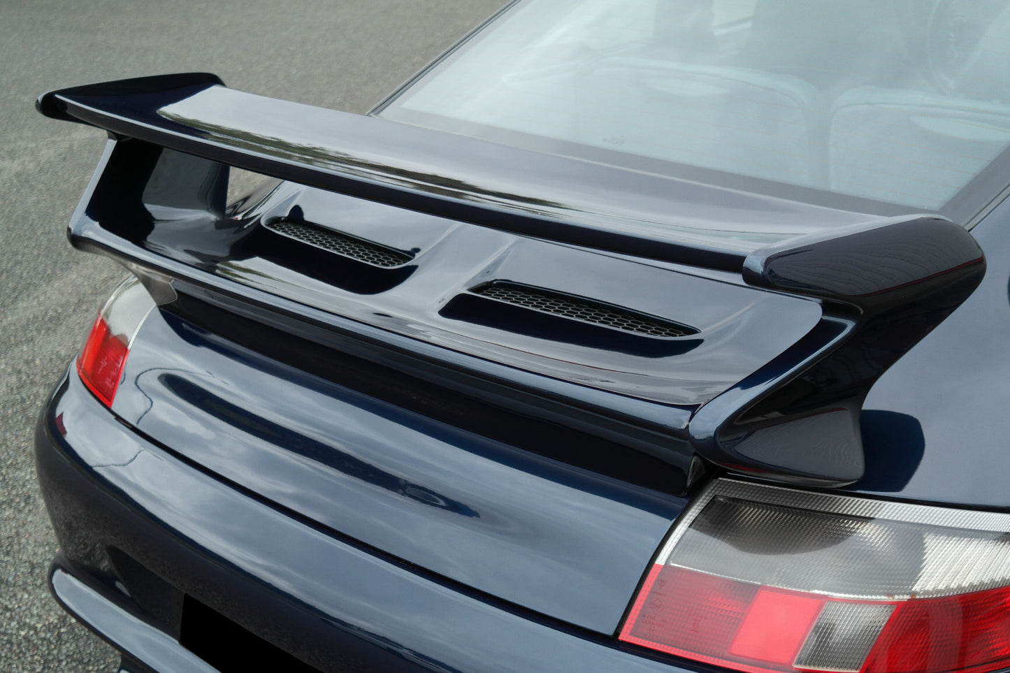 Back View of Rear Spoiler for Porsche 911/996 on vehicle. Made from 1st grade FRP (reinforced fiberglass)