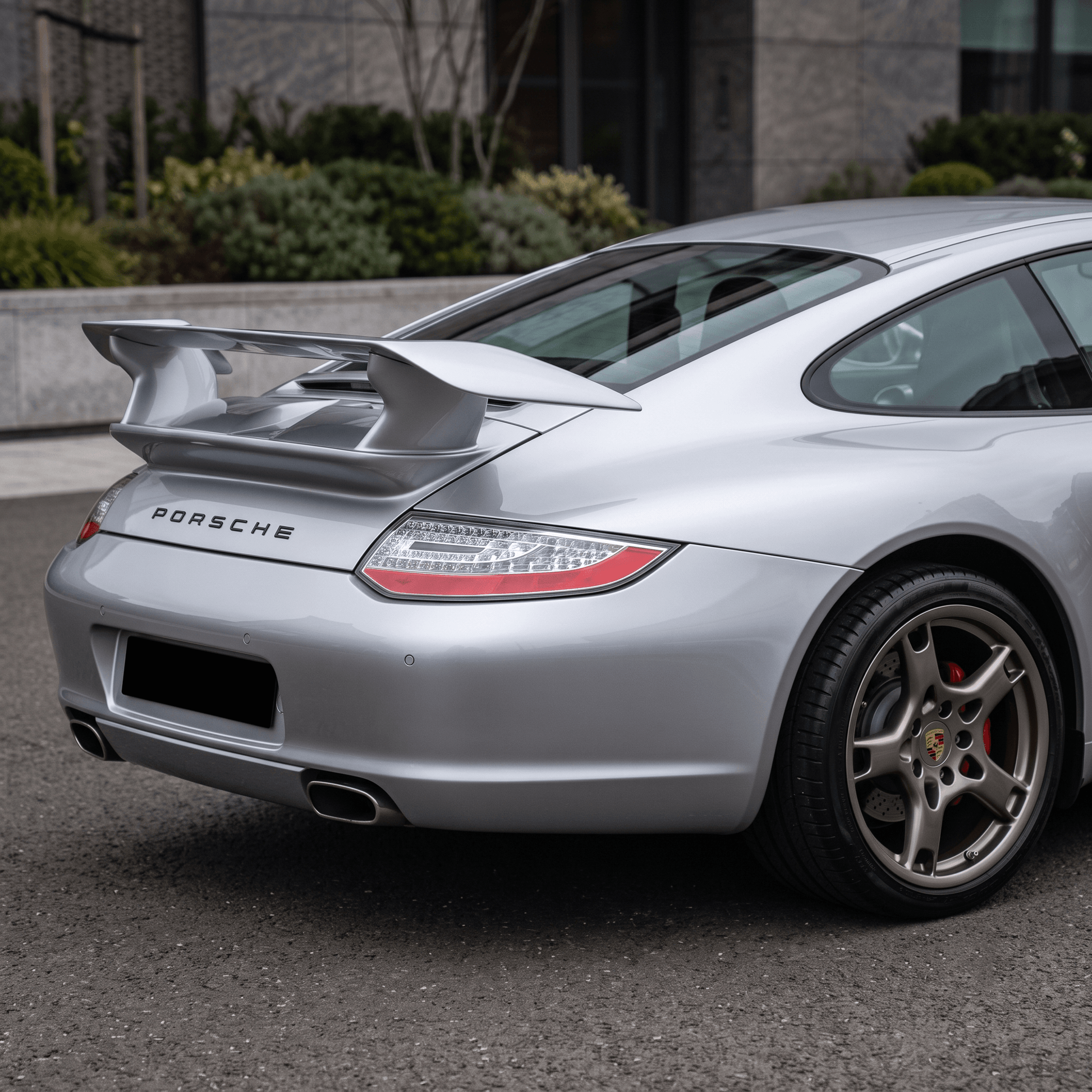 TRUNK SPOILER PORSCHE 911 997 fitted on a silver Porsche 911, shown from the rear three-quarter view