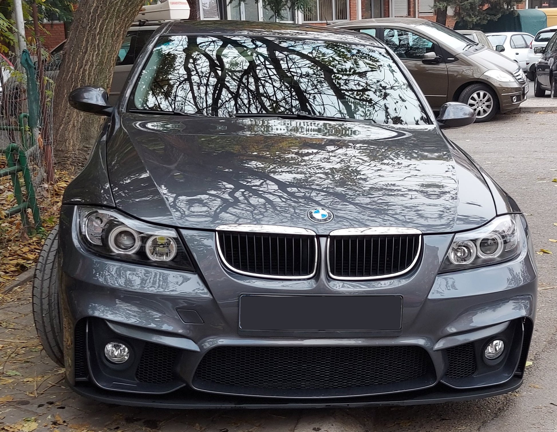 Front view of grey BMW E90 sedan with M4 style bumper and black front blade lip installed