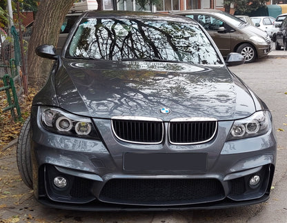 Front view of grey BMW E90 sedan with M4 style bumper and black front blade lip installed