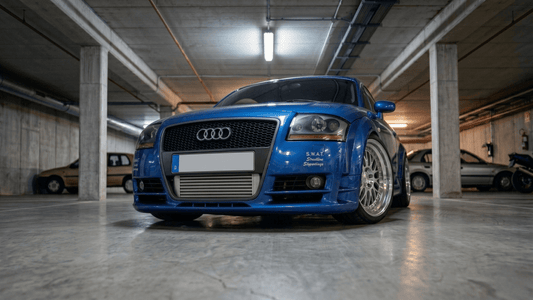 FRONT BUMPER AUDI TT 8N COMPETITIONFRONT BUMPER AUDI TT 8N COMPETITION fitted on a blue Audi TT, shown from the front view in a garage