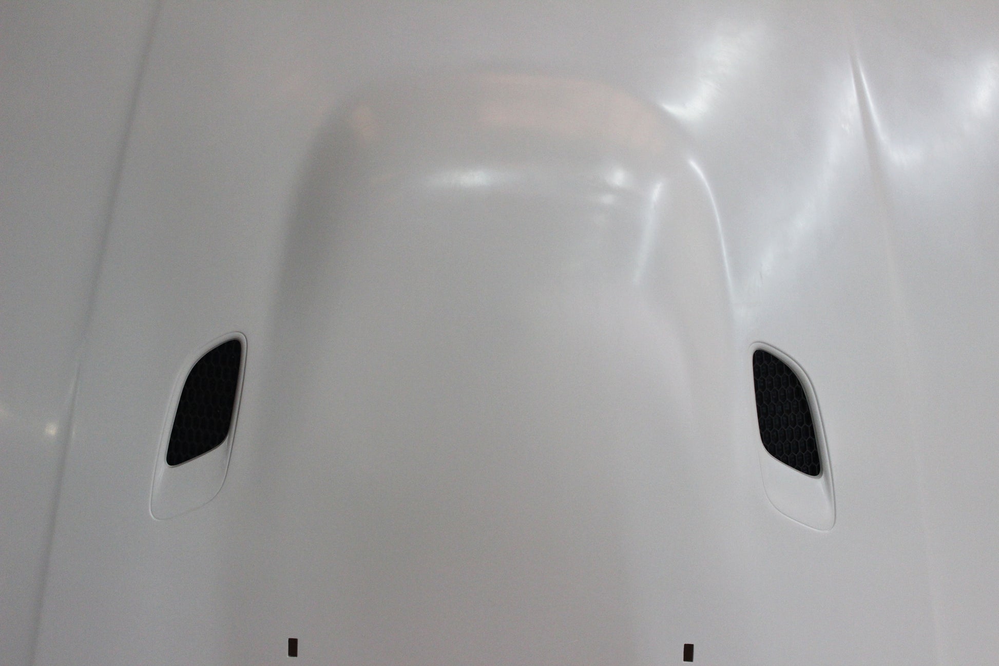 Detailed front view of bonnet BMW 1 Series E81/E82/E87/E88 M1 showing air vents and central bulge design.