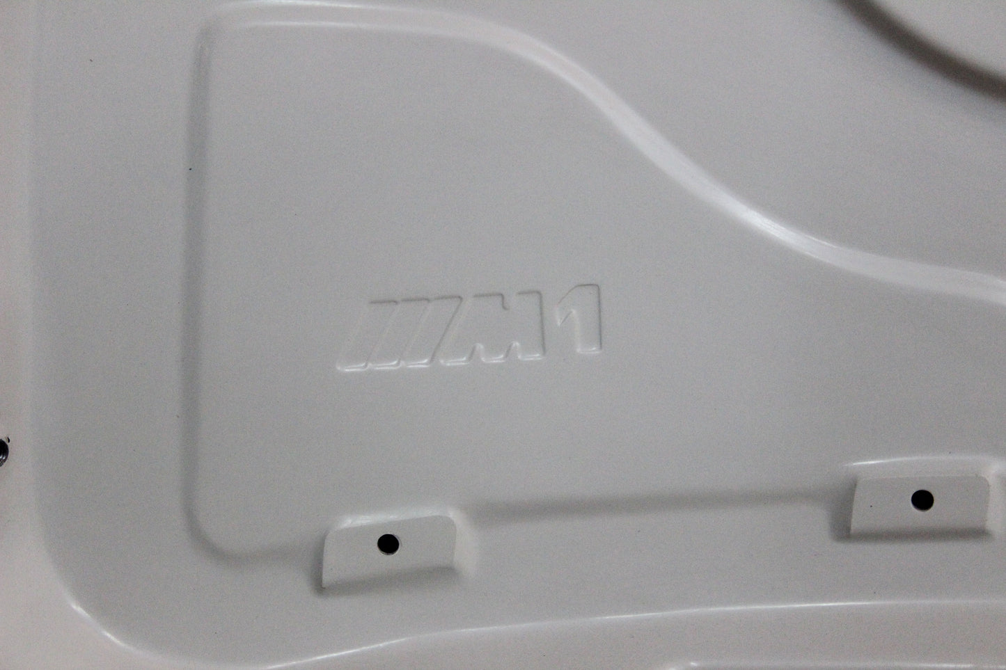 Underside of bonnet BMW 1 Series E81/E82/E87/E88 M1 showing integrated M1 logo pressed into the structure.