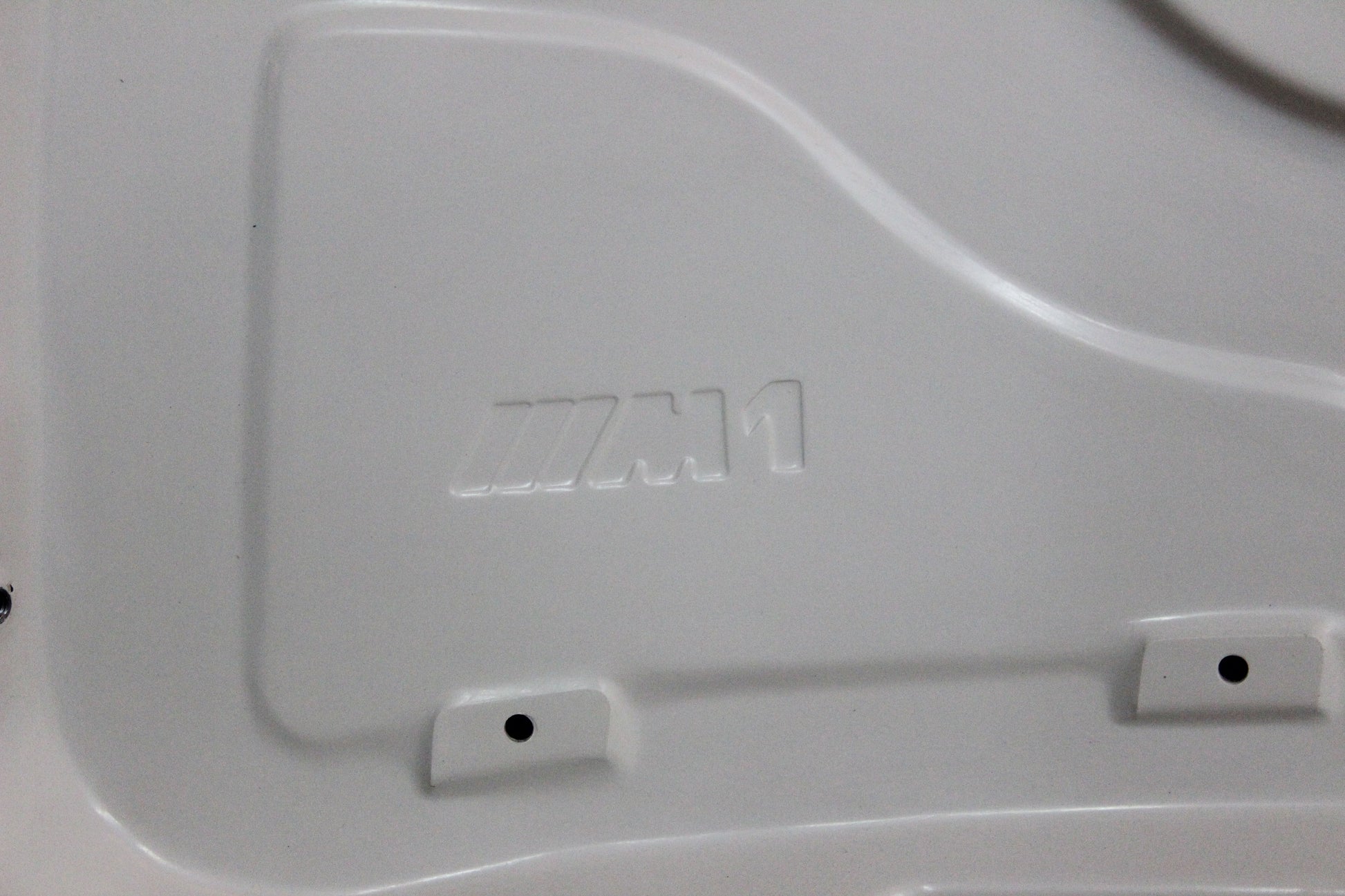 Underside of bonnet BMW 1 Series E81/E82/E87/E88 M1 showing integrated M1 logo pressed into the structure.
