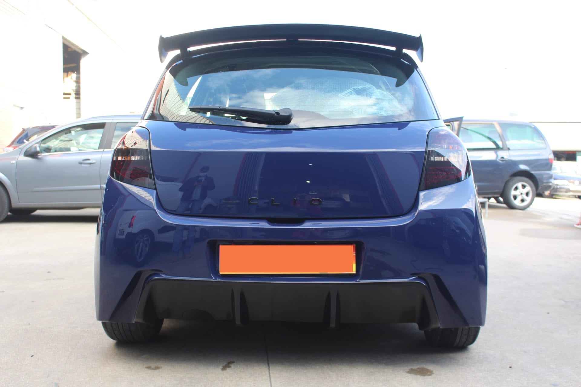 Back View of Roof Spoiler for Renault Clio III Sport on vehicle. Made from 1st grade FRP (reinforced fiberglass)