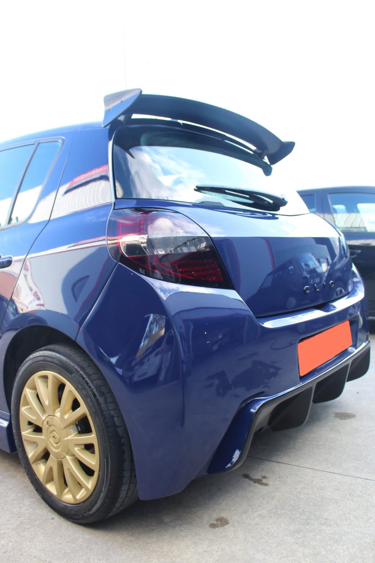 Back Side View of Roof Spoiler for Renault Clio III Sport on vehicle. Made from 1st grade FRP (reinforced fiberglass)