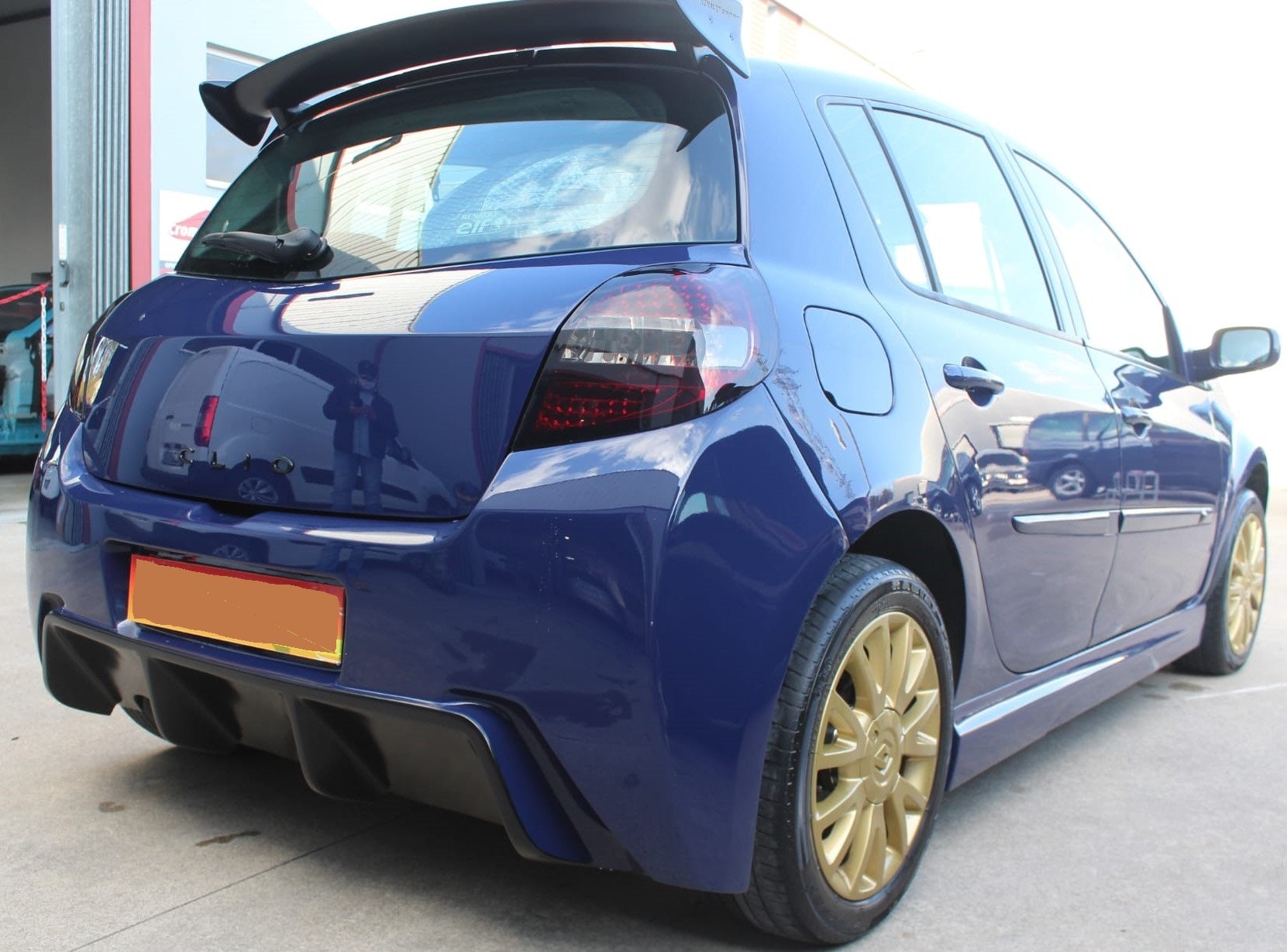 Back Side View of Roof Spoiler for Renault Clio III Sport on vehicle. Made from 1st grade FRP (reinforced fiberglass)
