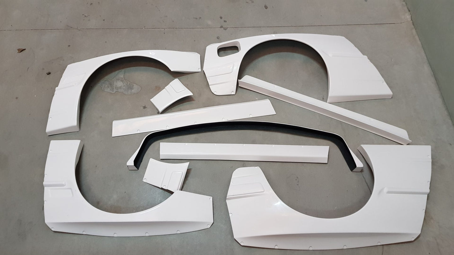 Body Kit BMW E30 Coupe "Rocket Bunny". Parts supplied: Front Lip, Front Fenders, Front Bumper Corners, Side Skirts, Rear Bumper Corners, Rear Panels, Trunk Spoiler