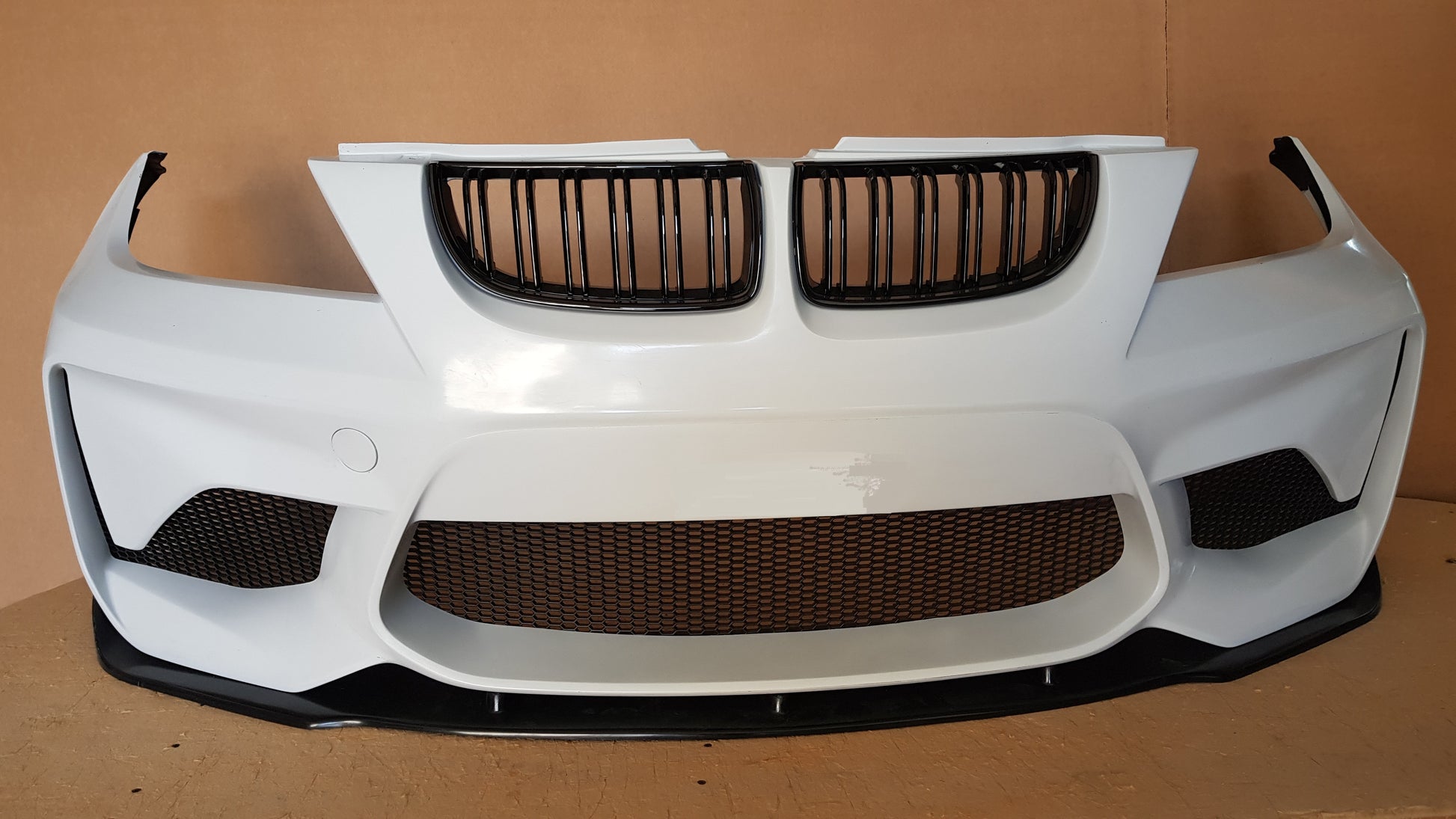 Front View of Front Bumper for BMW 3 Series E90/E91 PRE-LCI M2 Look. Made from 1st grade FRP (reinforced fiberglass)