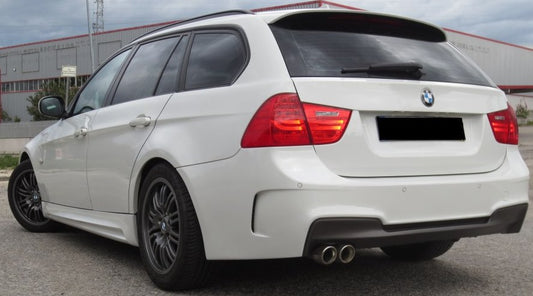 BMW 3 Series E91 Touring with 1M Look rear bumper, painted in white, featuring dual exhaust outlets, sporty lower diffuser, and modernized design for an aggressive appearance.