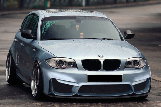 Front View of Front Bumper for BMW 1 Series E81/E82/E87/E88 M4 Look on vehicle, Fog Lights & Front Blade not included. Made from 1st grade FRP (reinforced fiberglass)