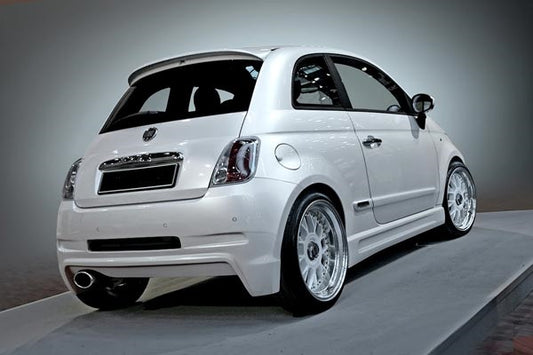 White Fiat 500 featuring a custom rear bumper with an integrated exhaust outlet and sporty aerodynamic design.