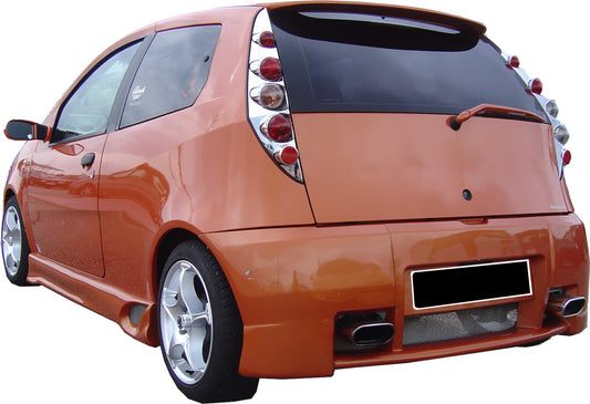Orange Fiat Punto 2000 fitted with an RS-style rear bumper, showcasing dual exhaust outlets and sporty mesh detailing for a performance-inspired look.