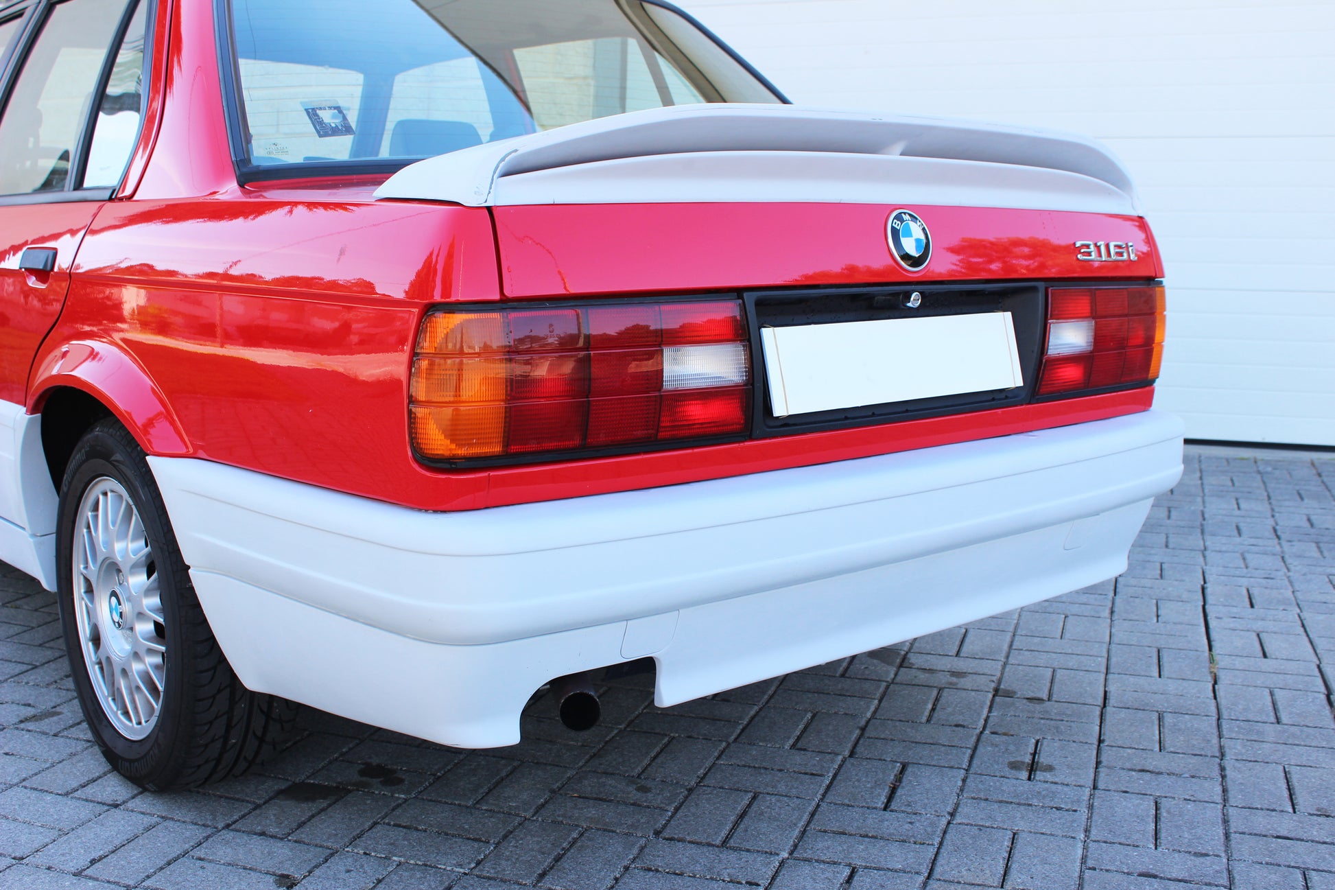 Back View of Rear Bumper for BMW 3 SERIES E30 M-TECK PH1 and PH2 on vehicle (4 Doors). Made from 1st grade FRP (reinforced fiberglass)