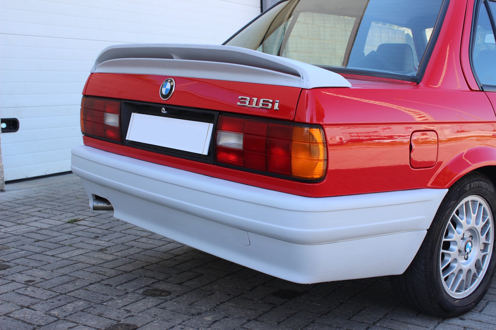 Back View of Rear Bumper for BMW 3 SERIES E30 M-TECK PH1 and PH2 on vehicle (4 Doors). Made from 1st grade FRP (reinforced fiberglass)